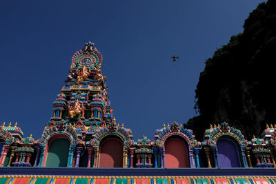 Low angle view of temple building against clear blue sky