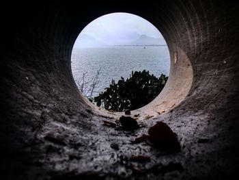 Scenic view of sea seen through hole