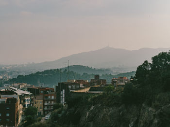 Buildings in city against clear sky