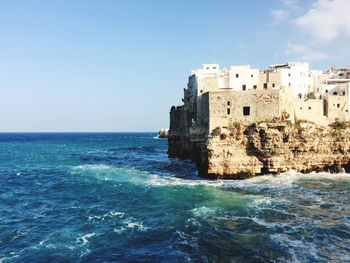 Scenic view of sea and buildings against sky