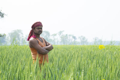 Portrait of happy indian farmer at agricultural field