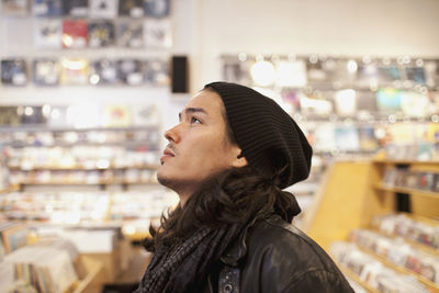 Young man browsing albums in a record store