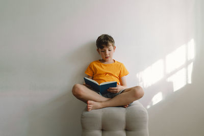 Portrait of young man using digital tablet at home