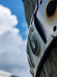 Close-up of old bicycle wheel against sky