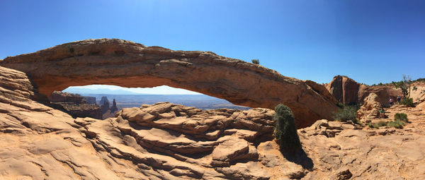 Scenic view of natural arches   against clear blue sky