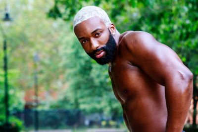 Portrait of shirtless man standing outdoors