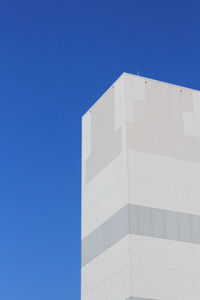Low angle view of building against clear blue sky