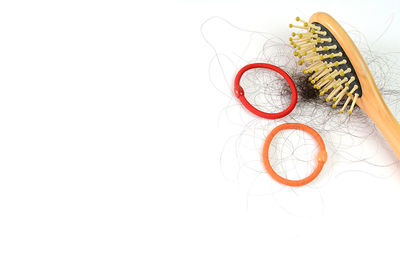 High angle view of multi colored paper against white background