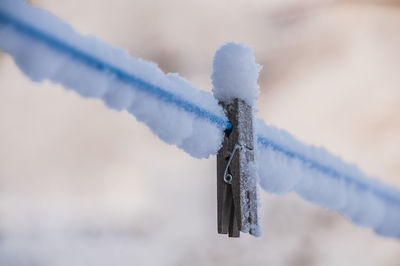 Close-up of icicles against blue sky during winter