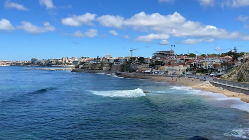 Panoramic view of sea and buildings against sky