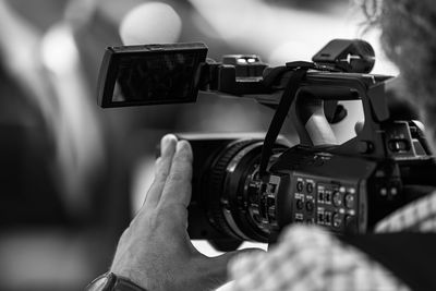 Camera at a media press conference publicity outdoors.