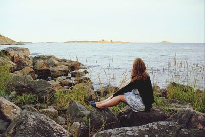 Rear view of man looking at sea