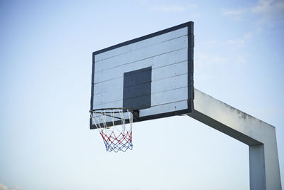 Low angle view of basketball hoop against blue sky