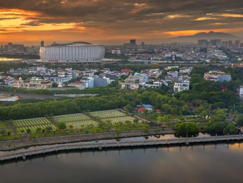 High angle view of buildings in city during sunset