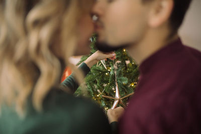 Midsection of woman holding christmas tree