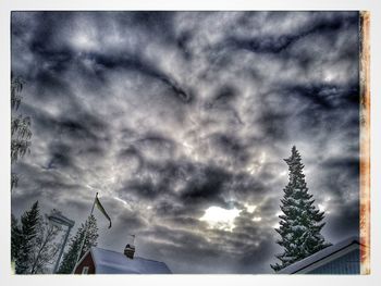 Low angle view of house against cloudy sky