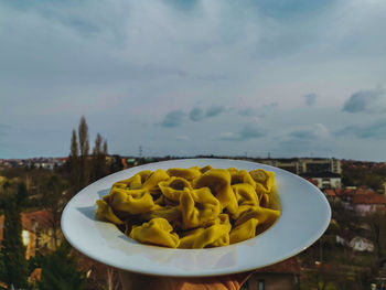 Close-up of fresh food in plate against sky