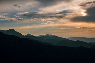 Scenic view of silhouette mountains against sky during sunset