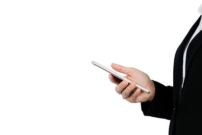 Midsection of man using smart phone against white background