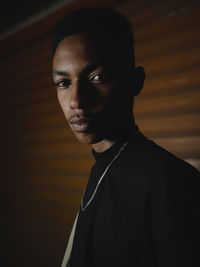 Side view of young man against wall