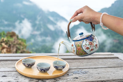 Hand holding tea cup