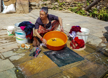 Mature woman washing clothes on sunny day