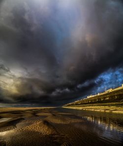 Scenic view of sea against storm clouds