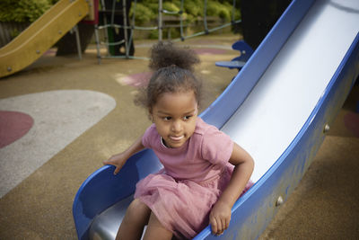 Girl having fun on slide in playground