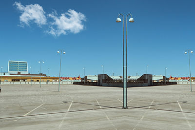 Empty road by street light against sky