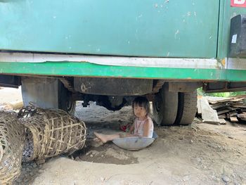 Rear view of girl sitting in bus