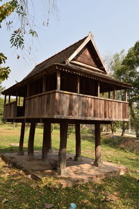 Built structure by trees against sky