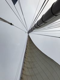 Low angle view of suspension bridge against sky