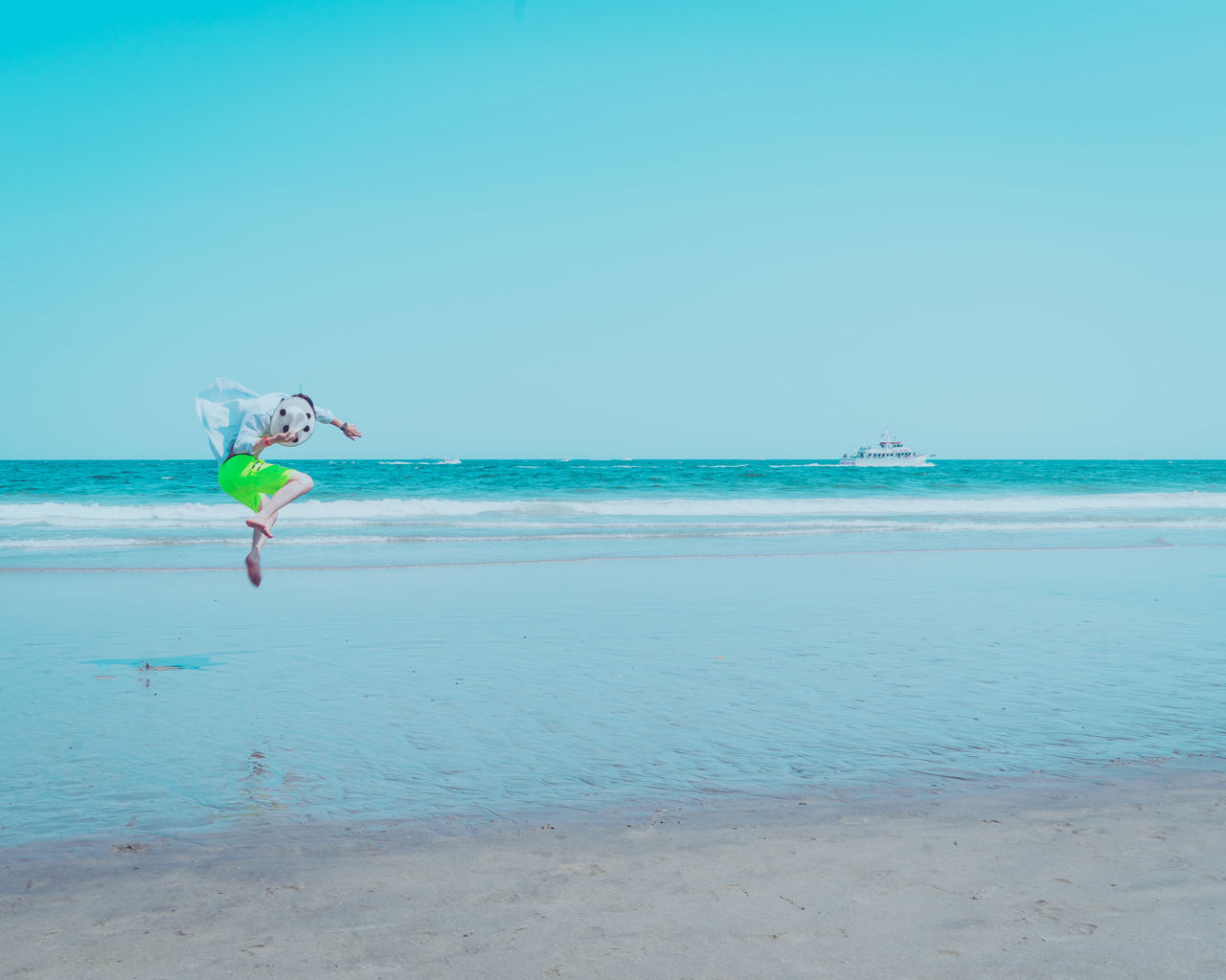 MAN SURFING ON BEACH