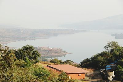 High angle view of river and buildings against sky