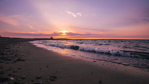 Scenic view of beach against sky during sunset
