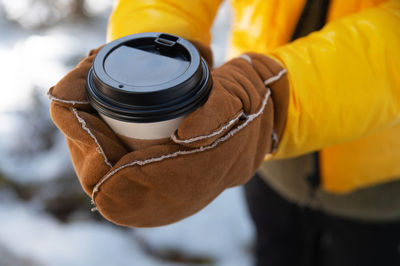Midsection of man holding lantern
