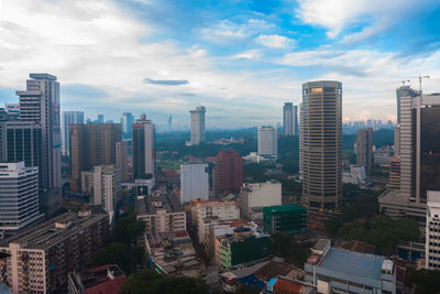 High angle view of city against blue sky