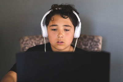 Boy doing his homework on laptop