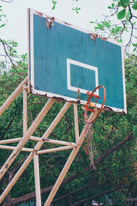 Low angle view of basketball hoop against trees