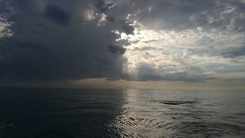 Scenic view of sea against storm clouds