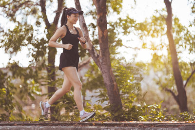 Full length of woman running on tree