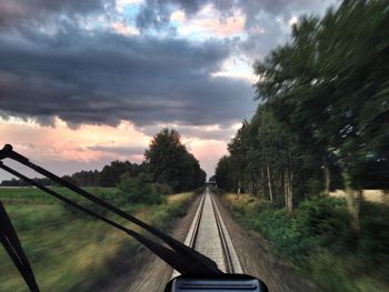 View of railroad tracks against cloudy sky