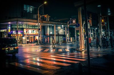 Illuminated city street at night