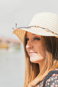 Portrait of young woman wearing hat