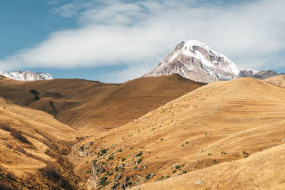 Scenic view of snowcapped mountains against sky