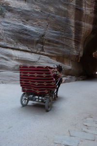 Person on road by rock formation in winter