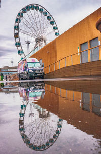 Ferris wheel in city against sky