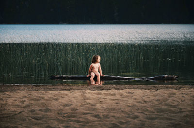 Full length of shirtless boy in water