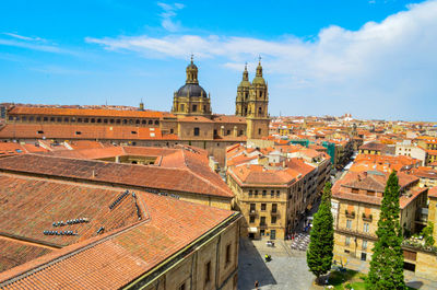 High angle view of buildings in town against sky