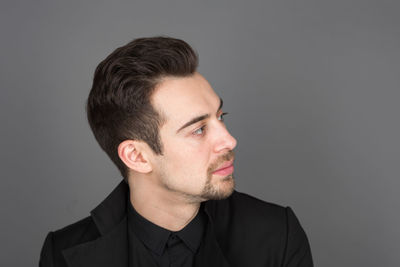 Portrait of young man against white background